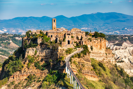 The famous Civita di Bagnoregio on a sunny day. Province of Viterbo, Lazio, Italy. Medieval town on the mountain, Civita di Bagnoregio, popular touristic stop at Tuscany, Italy.