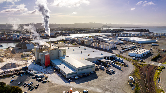 High quality stock photo of a drywall manufacturing plant next door to a pipeline storage facility in  Richmond California.