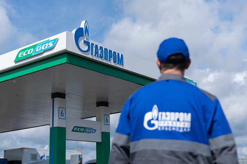 Krasnodar, Russia - April 21, 2023 An employee of a Gazprom gas station in front of a gas filling station. Ecogas.