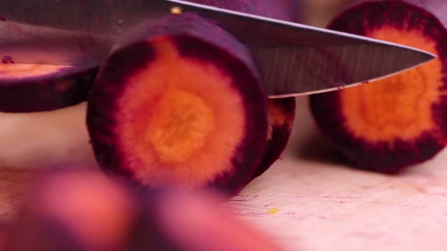 Pieces of sliced peeled carrots are red-orange in color