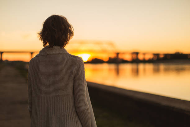 istock Woman enjoying sunset 1484595073