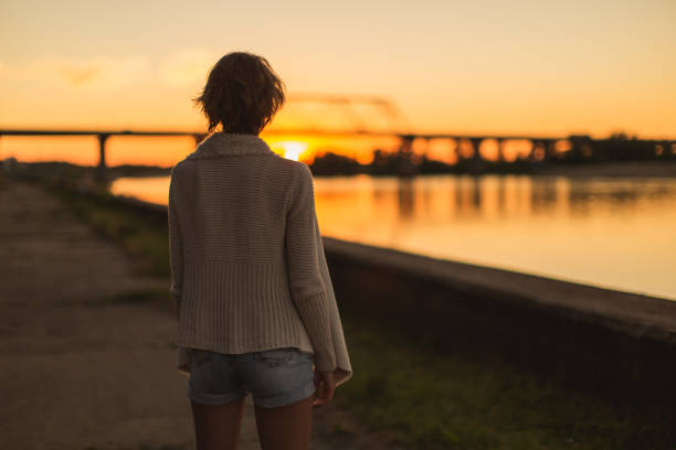 istock Woman enjoying sunset 1484595146