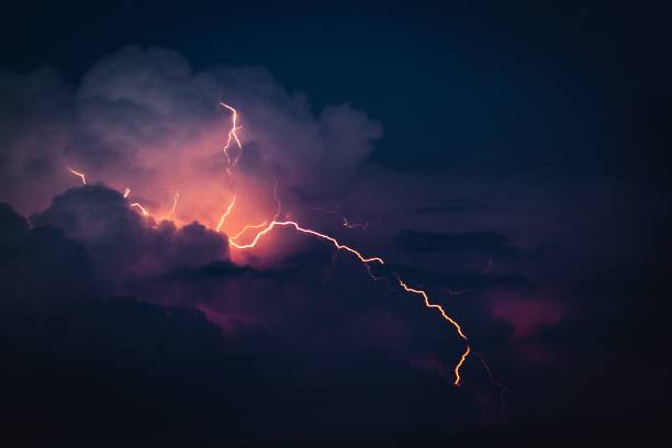 istock Dramatic sky with illuminated clouds by a lightning strike over a cityscape at night 1484596716
