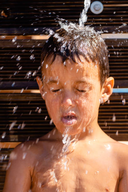 istock Boy enjoyes water refreshment from the tap 1484597191