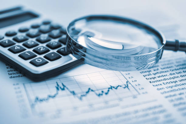 istock Magnifying glass, calculator and charts on paper 1484607843