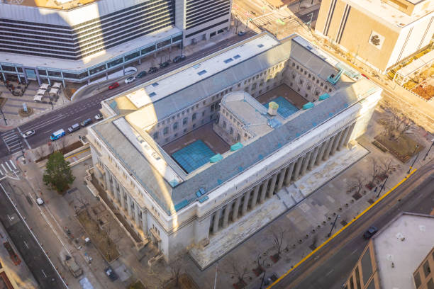 Stately historic Courthouse with distinctive clock tower stands tall amidst modern skyscrapers in downtown Fort Wayne, Indiana. A symbol of heritage and progress.