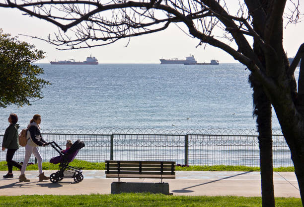 Istanbul, Turkey - April 8, 2023: People resting and walking near sea at Florya bakırköy istanbul near marmara sea in a sunny spring day.