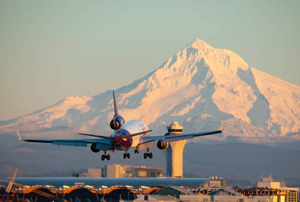 Portland, Oregon, USA - January 29, 2023: The FedEx Express MD-11 named Alyssa comes in for a landing at Portland International with Mt Hood in the background.
