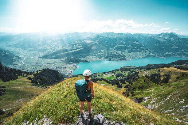 istock Mountaineer enjoys the panoramic view on Walensee from a beautiful view point next to the hike trail. Schnürliweg, Walensee, St. Gallen, Switzerland, Europe. 1484633417