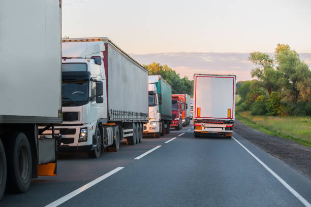 istock Trucks move in opposite directions on highway 1484639138
