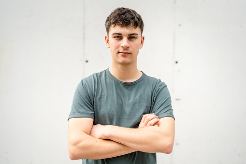 One man young adult caucasian teenager stand outdoor posing portrait looking to the camera happy confident wear shirt casual real person copy space