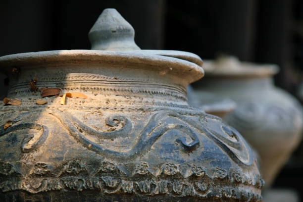 Old Thai traditional stone vase on outdoors ground. Group of Thai dragon classical antique pattern vase in Ratchaburi province of Thailand. Industrial and Handmade manufacturing concept.