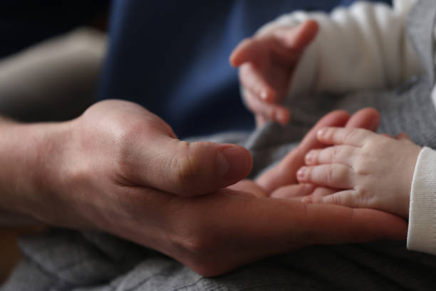 istock Newborn boy sleeping on his father's lap 1484653911