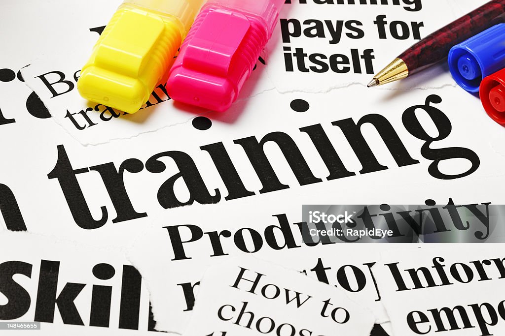 Highlighters sit on headlines about training Colorful highlighters and a pen sit on a selection of press headlines about skills training for improved productivity. Shot with Canon EOS 1Ds Mark III.  Alphabet Stock Photo