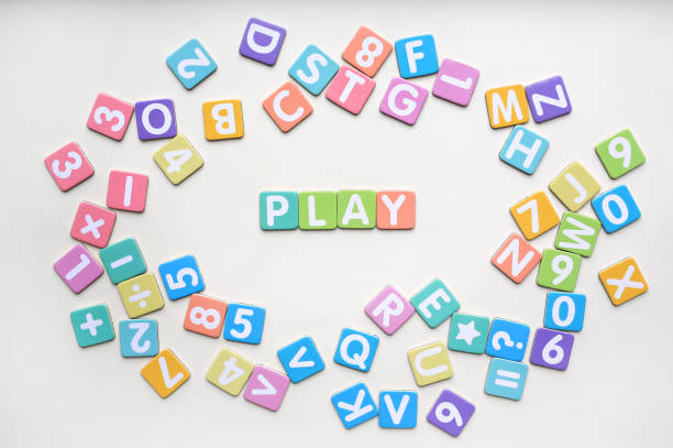 Multi-color Alphabet ABC letters and number and mathematics sign in square flat papers on white background with PLAY at center.