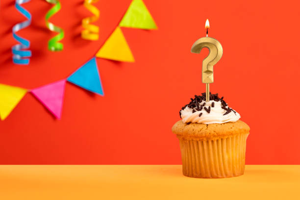 istock Birthday cake with question mark - Orange background with pennants 1484668035