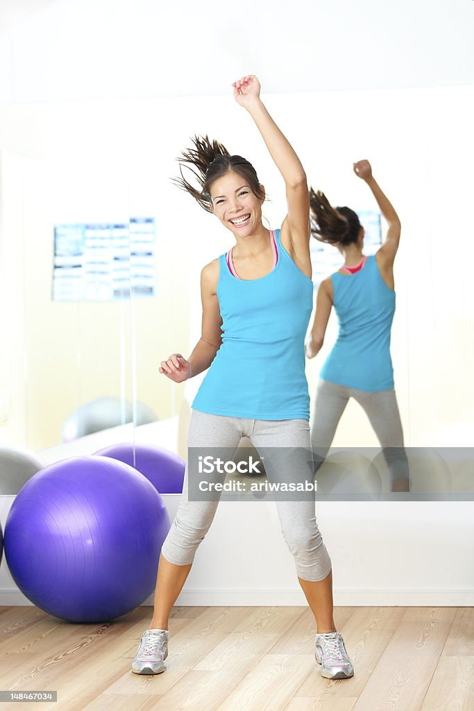 Dancing Gym aerobics fitness dance instructor Gym aerobics zumba fitness dance instructor. Woman dancing happy in fitness center. Young beautiful mixed race Caucasian / Chinese Asian female fitness model. Gym Stock Photo