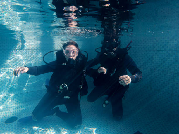 istock Couple in wetsuits in the pool during pool practice 1484671767