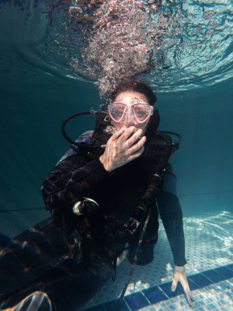 istock Portrait of a woman looking at the camera in a wetsuit while practicing in a pool 1484672319