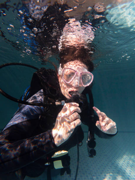 istock Portrait of a woman looking at the camera in a wetsuit while practicing in a pool 1484672329