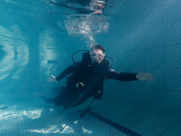 istock Woman looking at camera in wetsuit during practice in pool 1484672348