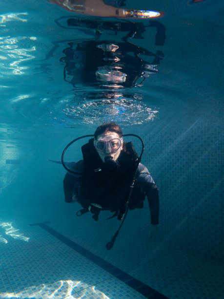 istock Woman looking at camera in wetsuit during practice in pool 1484672362