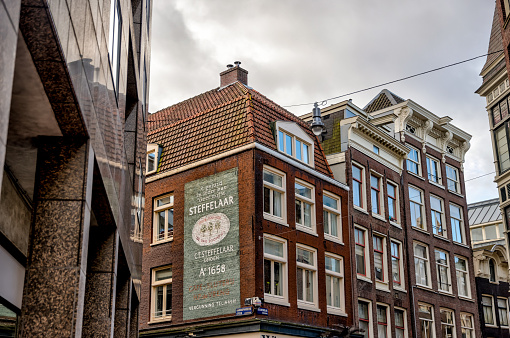 Amsterdam, Netherlands - March 28, 2023: Iconic houses along the streets and canals of Amsterdam