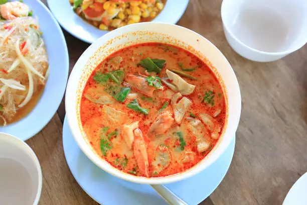 Photo of Tom Yum Goong is Thai famous soup with Chili pepper, shrimp, mushroom, lemon grass, lemonand galangal. Thailand Food