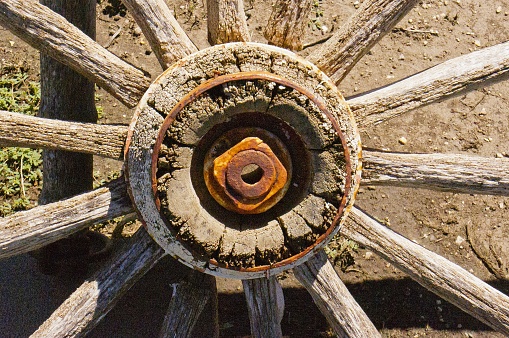 A closeup of a wooden wheel hub on a conestoga covered wagon.