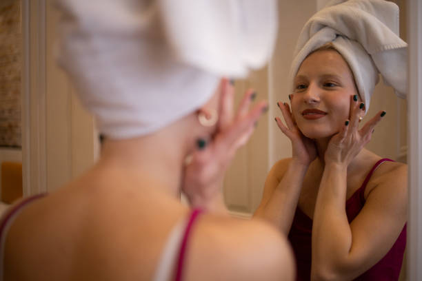 istock Handsome woman applying moisturizer to his face 1484683243