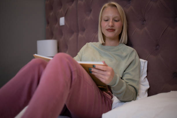 istock Woman relaxing and reading a book 1484683258