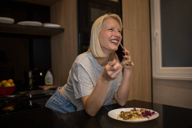 istock Beautiful young woman having breakfast in the kitchen 1484683276