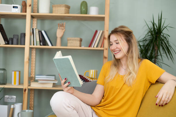 istock Young woman relaxing and reading on the sofa 1484683384