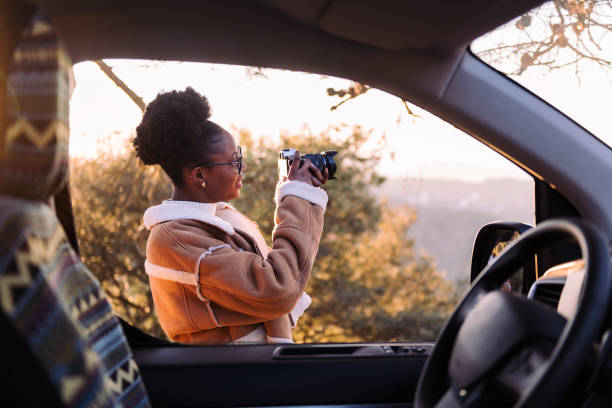 woman taking photos of nature during a road trip