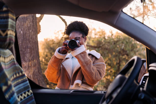 istock woman taking photos with camera during a road trip 1484683788