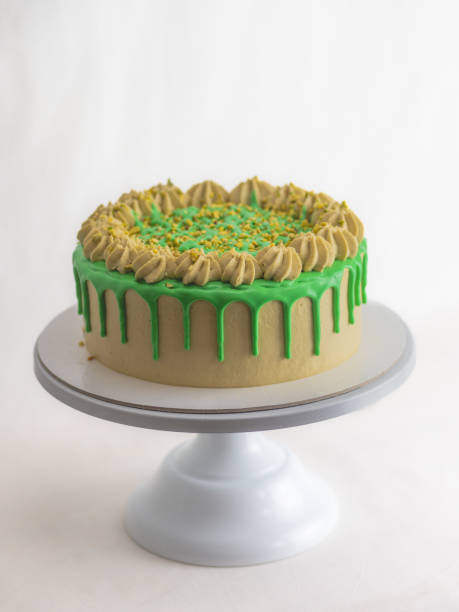 istock green pistachio frosted dripped icing cup cake with sprinkles on top 1484684014