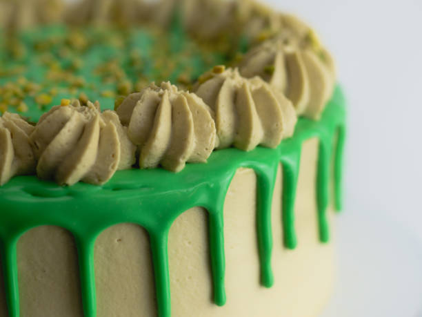istock green pistachio frosted dripped icing cup cake with sprinkles on top 1484684018