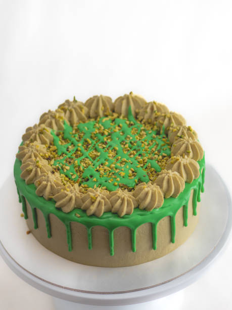 istock green pistachio frosted dripped icing cup cake with sprinkles on top 1484684019