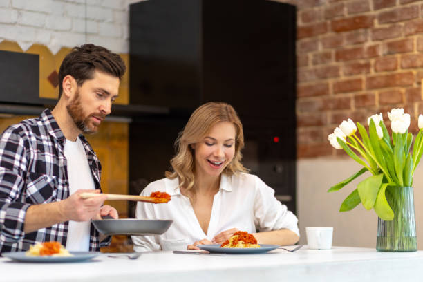 istock Happy family having dinner in kitchen serving table at home in domestic kitchenn. 1484692497