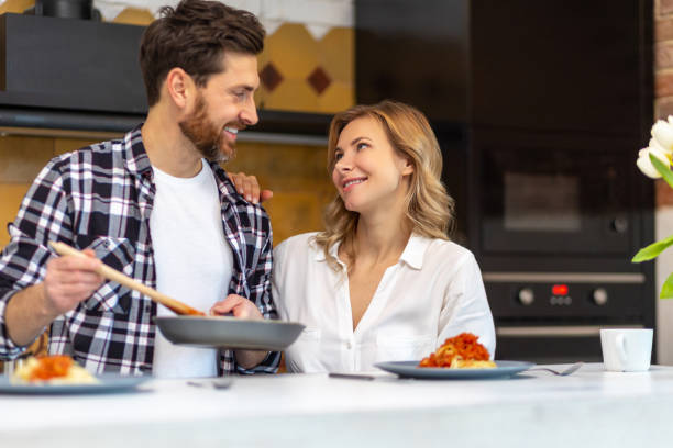 istock Happy family having dinner in kitchen serving table at home in domestic kitchenn. 1484692502