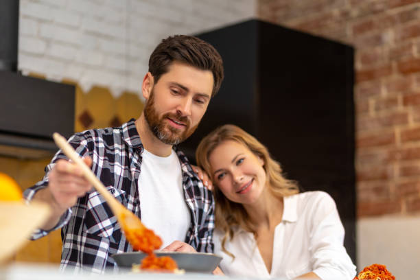istock Happy family having dinner in kitchen serving table at home in domestic kitchenn. 1484692518