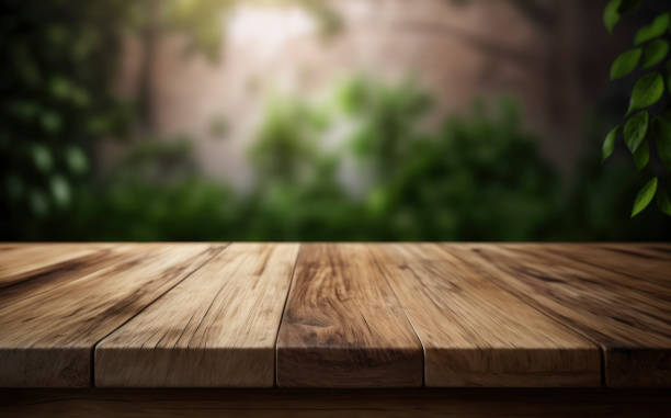 istock wooden table top with blurred green nature and leafs background 1484696419