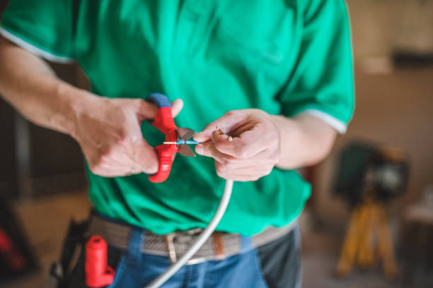istock Unrecognizable electrician cuts cables with wire cutters 1484705380