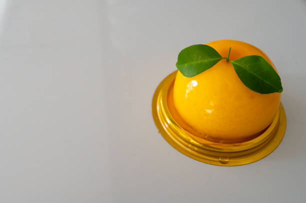 istock Round orange cake on white table. Dessert. Obesity 1484707110