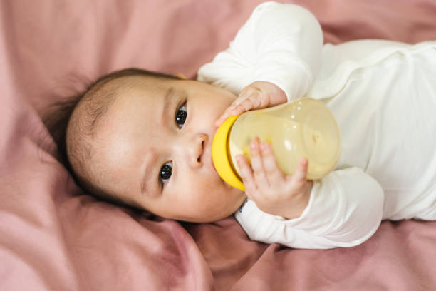istock image of a newborn baby lying on a pink bed 1484709728