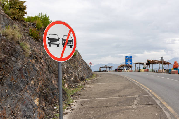 istock Prohibit overtaking sing post on a road side in the hilly mountain area 1484709776