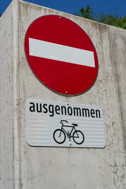 Entrance forbidden sign on a road, with the german lettering Fahrrad ausgenommen. Translation: bicycles allowed