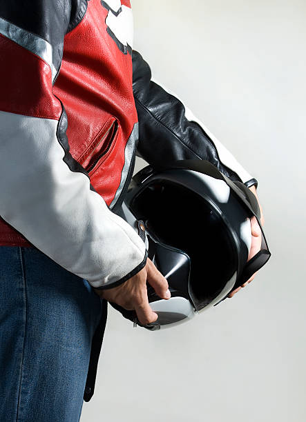 bikerjacke mit helm motorrad - motocross jeans denim biker stock-fotos und bilder