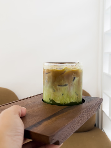 A glass of iced greentea and layer of coffee, stock photo