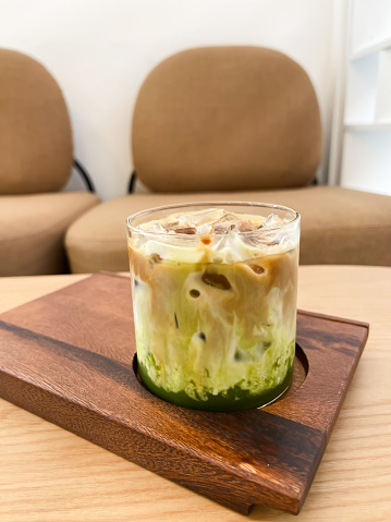 A glass of iced greentea and layer of coffee, stock photo